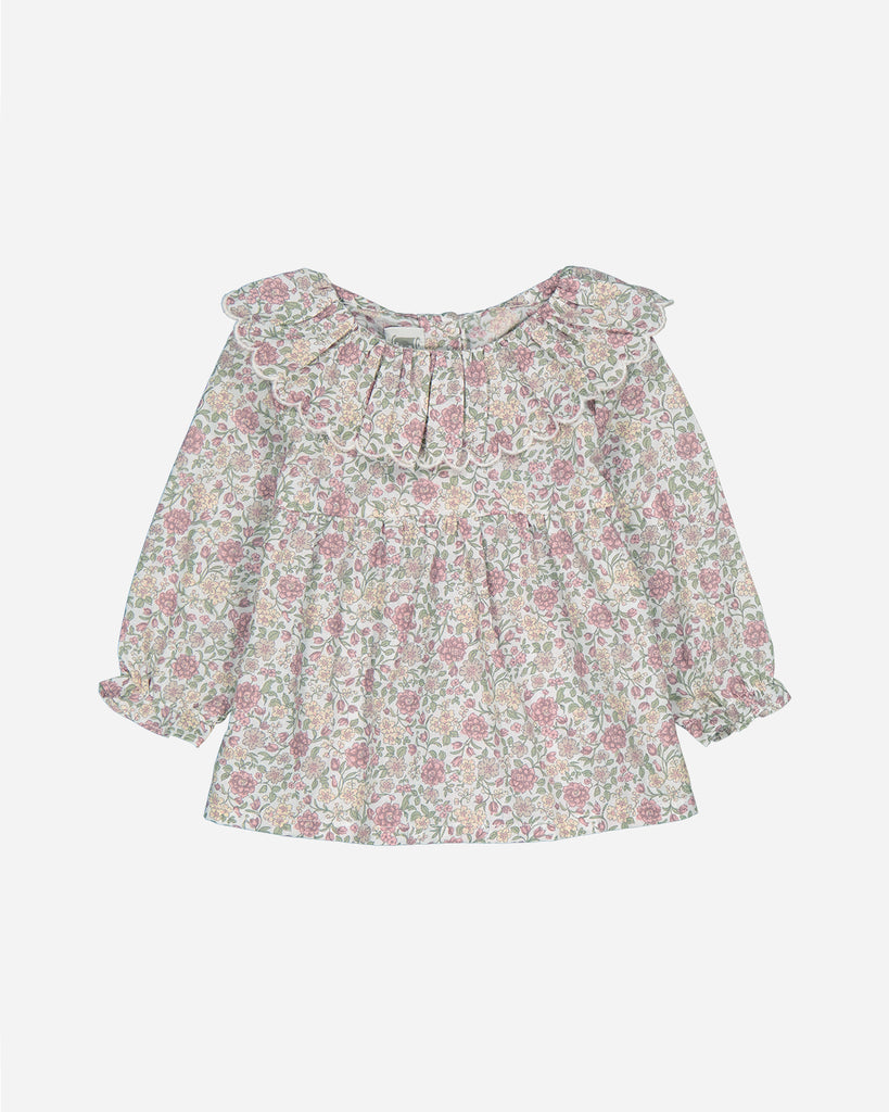 Blouse à imprimés mauves doté d'un col volant.