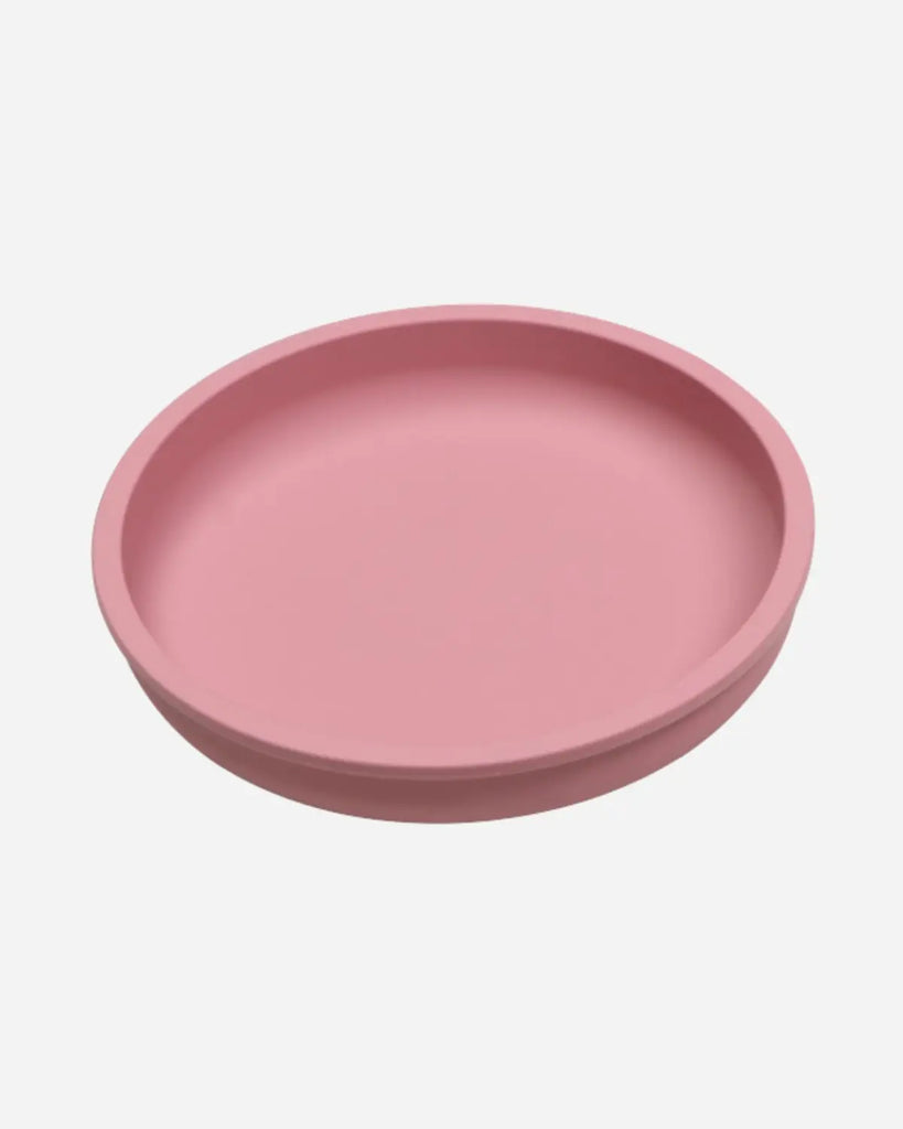 Vue de cote de l'assiette en silicone ronde de couleur rose pour bébé et enfant