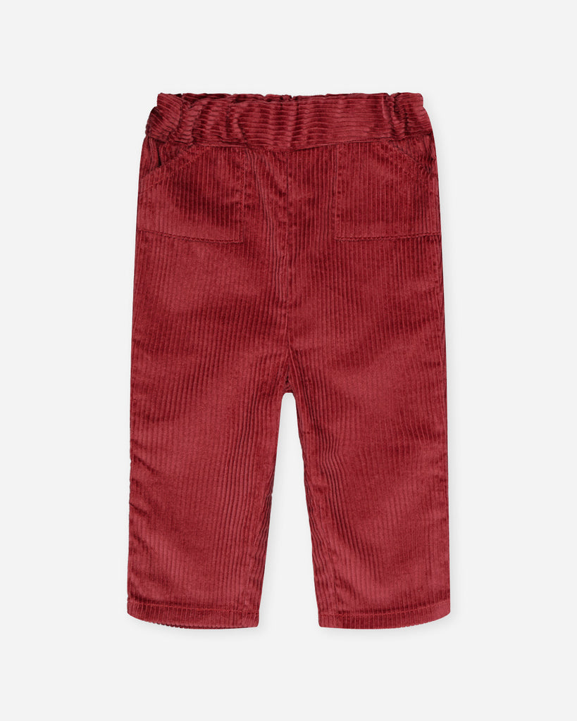 Pantalon en velours côtelé rouge brique avec deux poches de chaque côté de la marque Bobine Paris.