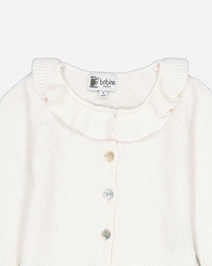 Zoom du cardigan pour bébé fille écru à col volanté en laine et cachemire de la marque Bobine Paris.