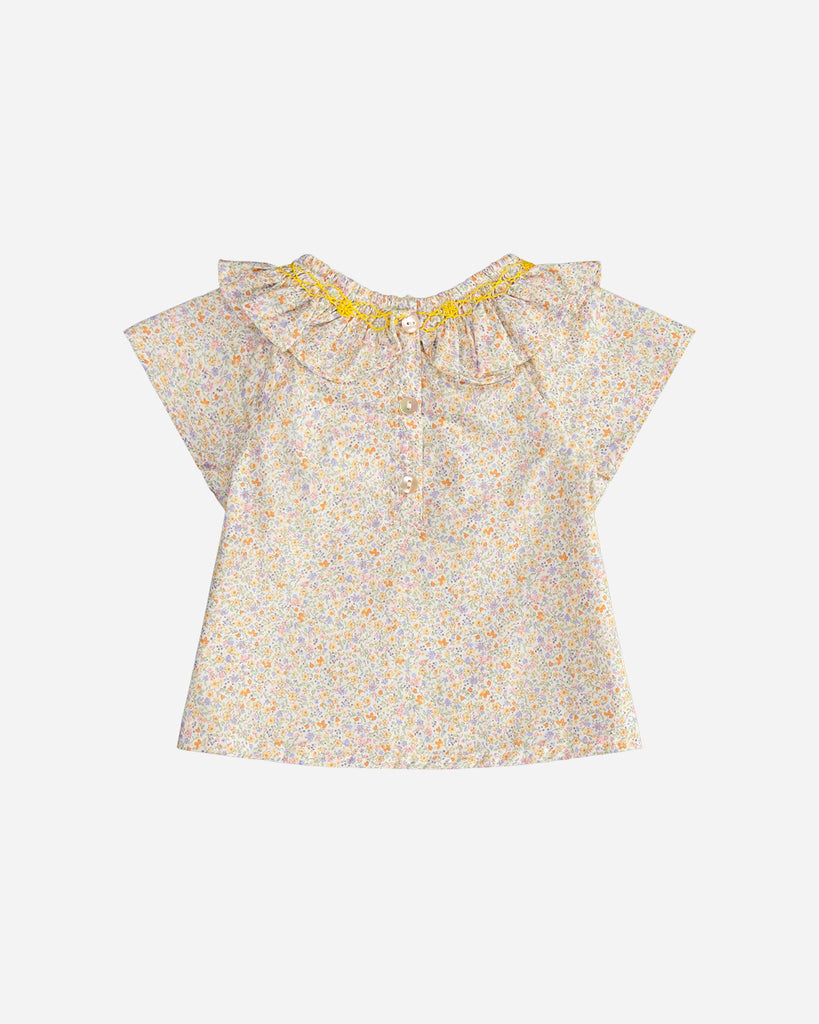 Vue de dos de la blouse pour bébé fille à col volanté et motif fleuri jaune de la marque Bobine Paris.