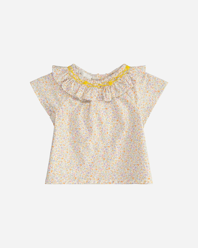 Blouse pour bébé fille à col volanté et motif fleuri jaune de la marque Bobine Paris.