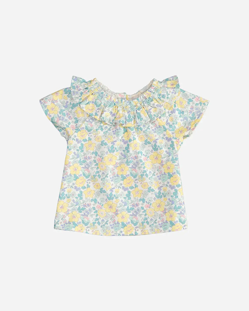 Blouse pour bébé fille à col volanté et motif fleurs émeraude et jaune de la marque Bobine Paris.