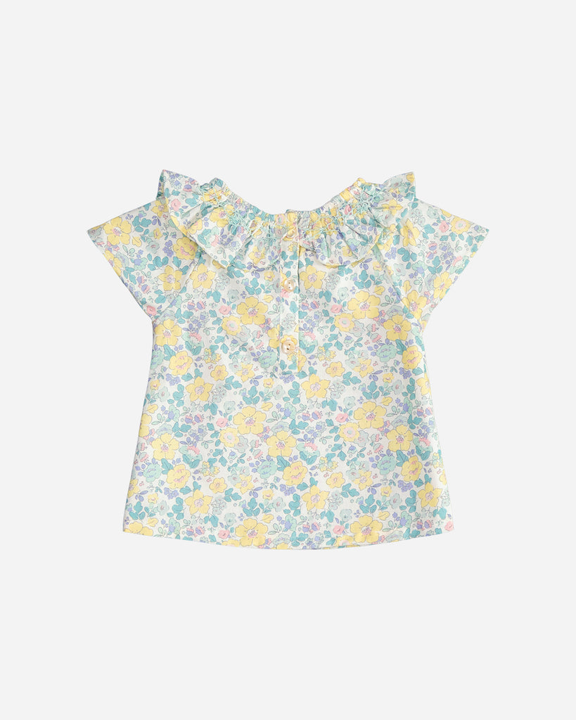 Vue de dos de la blouse pour bébé fille à col volanté et motif fleurs émeraude et jaune de la marque Bobine Paris