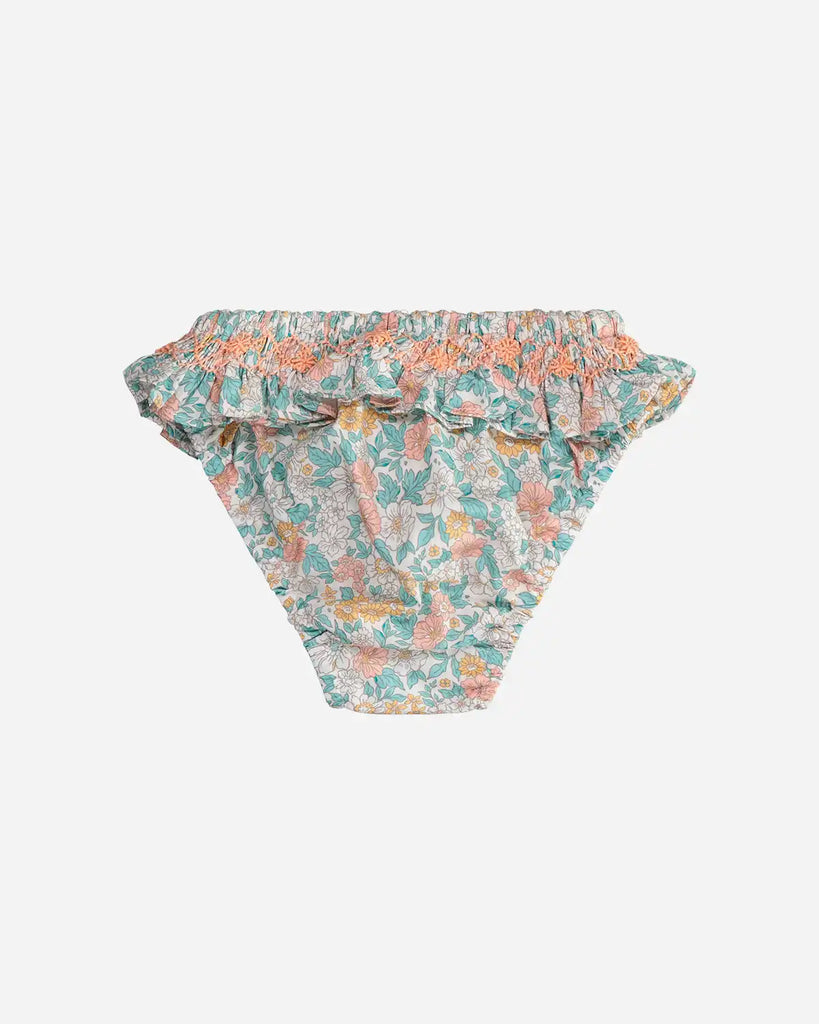 Vue de dos de la culotte de bain fleurie pour bébé fille couleur amande et corail de la marque Bobine Paris
