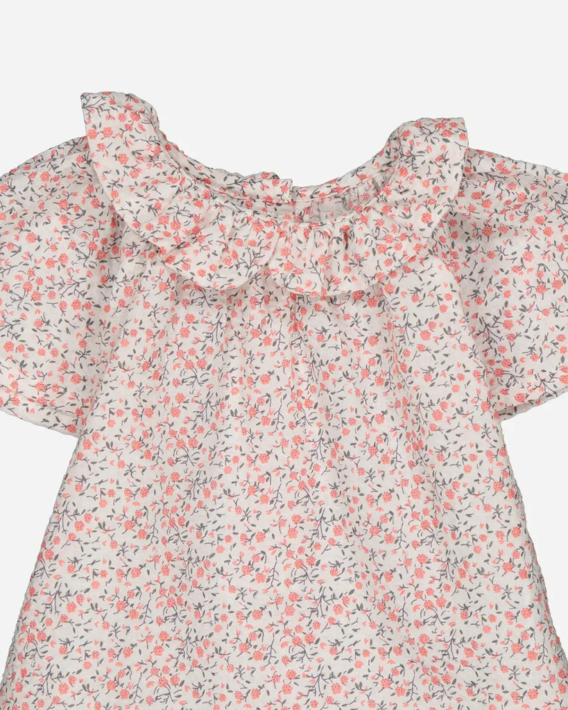 Zoom de la blouse pour bébé fille à imprimé fleurs de cerisier de la marque Bobine Paris.