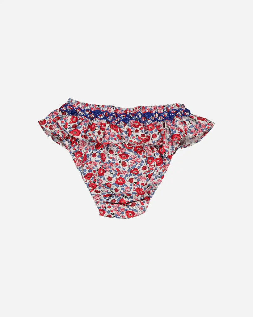 Vue de dos de la culotte de bain bébé fille à froufrous et motifs fleuris rouge de la marque Bobine Paris.
