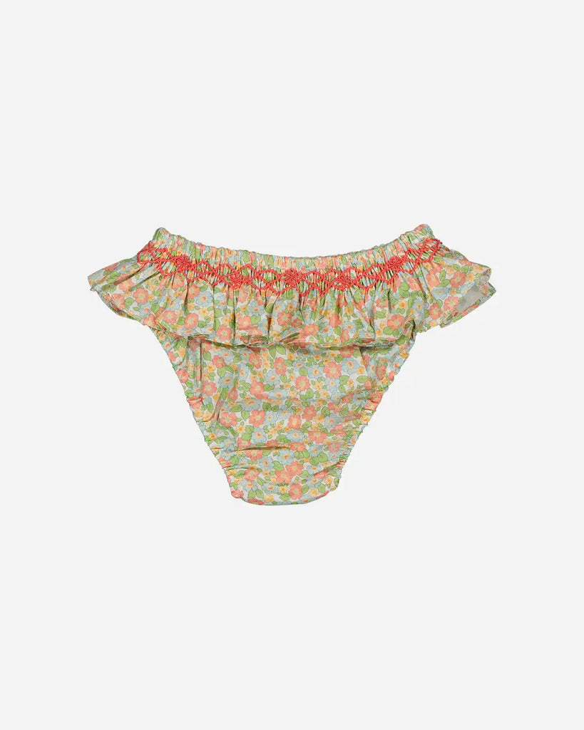 Vue de dos de la culotte de bain à froufrous et motifs fleuris prairie verte pour bébé fille de la marque Bobine Paris.