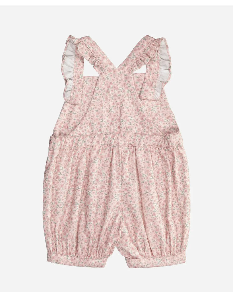 Vue de dos de la salopette pour bébé fille courte blanche fleurie rose en gaze de coton de la marque Bobine Paris.