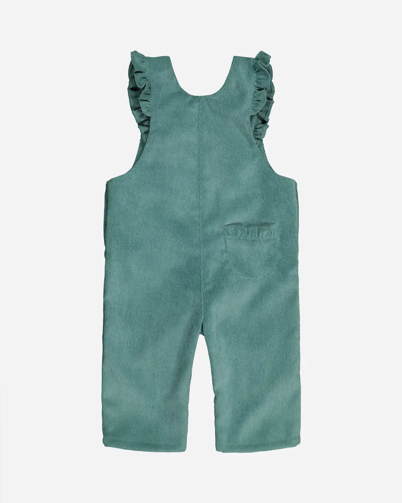 Vue de dos de la salopette pour bébé fille vert amande avec bretelles et poches à volants de la marque Bobine Paris.