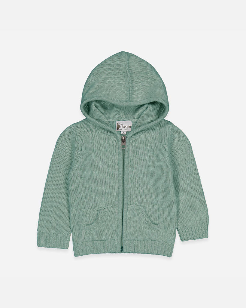 image d'un gilet bébé zippé à capuche de couleur vert amande en laine et cachemire Bobine Paris