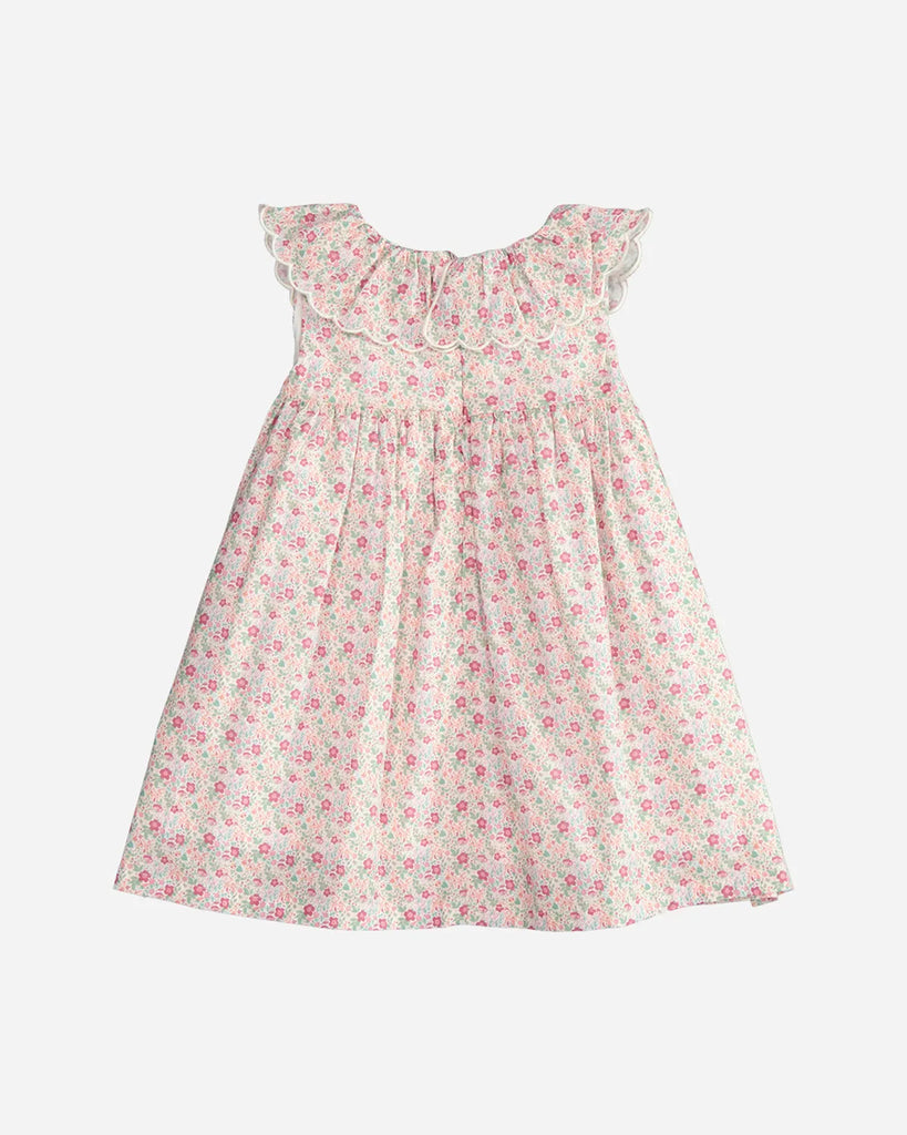 Vue de dos de la robe pour bébé fille à fleurs roses, vertes et oranges et col bordé de la marque Bobine Paris.