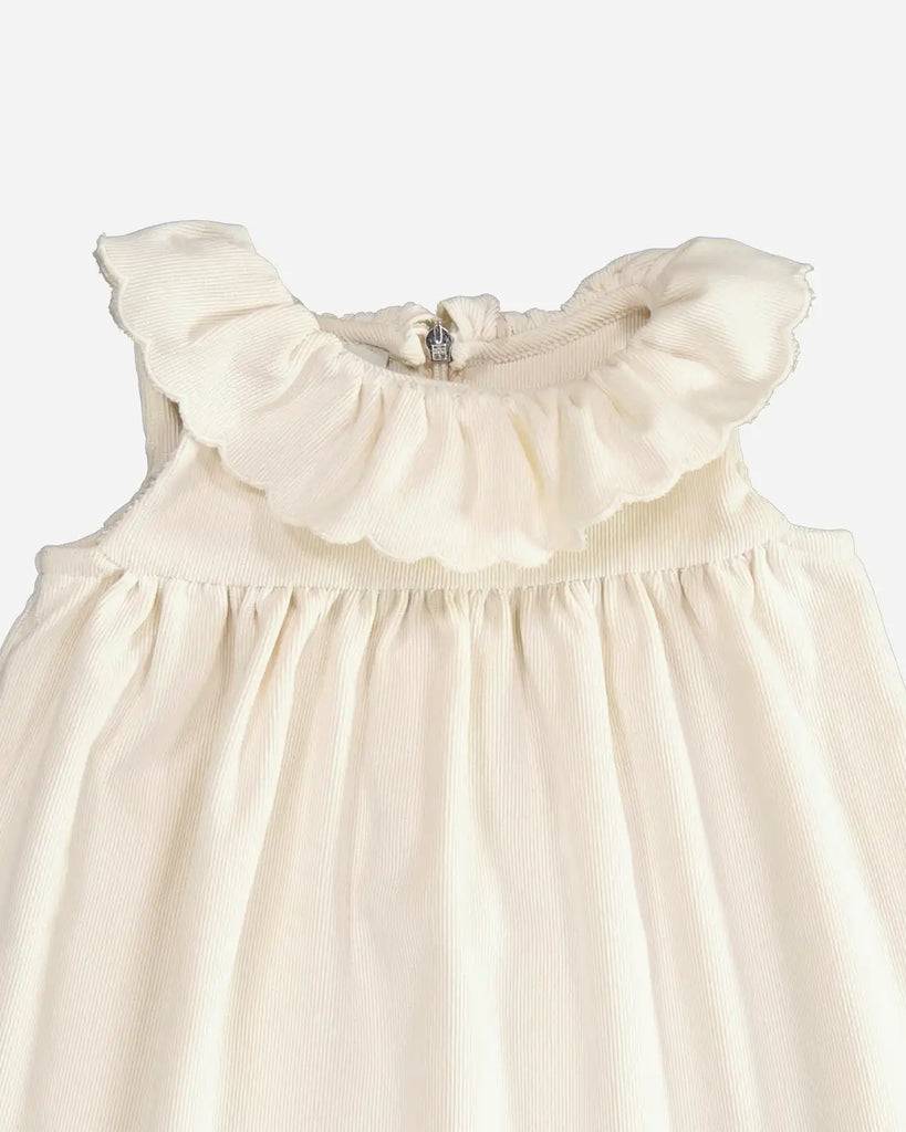 Zoom de la robe pour bébé fille écru en velours côtelé et à col bordé de la marque Bobine paris.