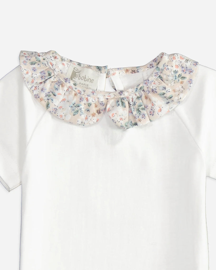 Zoom du t-shirt pour bébé fille à manches courtes et à col volanté beige fleuri de la marque Bobine Paris.