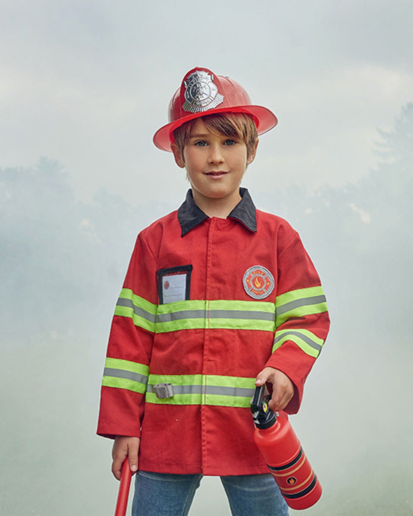 Petit garçon portant une veste de déguisement de pompier rouge à rayures jaunes fluo avec un casque, un extincteur et une hache